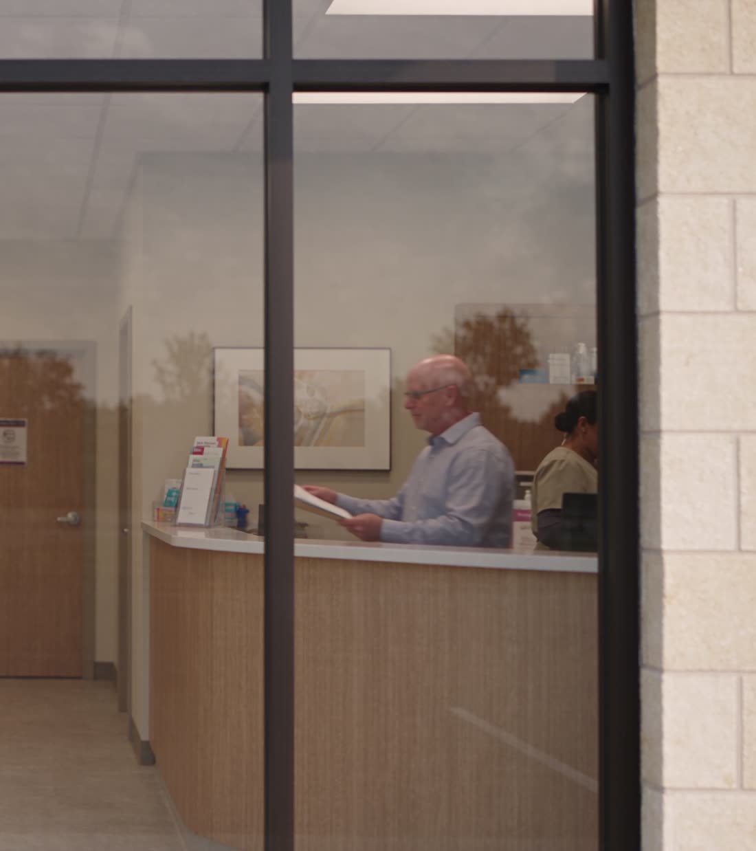 Rendering of a practice reception desk seen through storefront glass